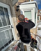 A person installs or repairs a security camera